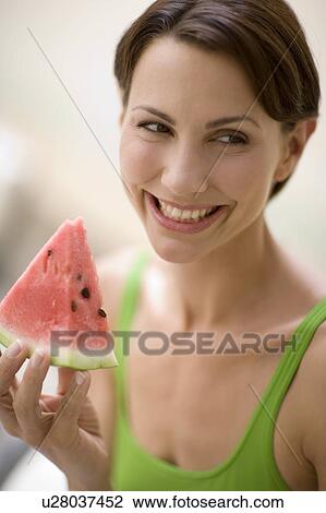 Woman eating watermelon View Large Photo Image Stock Image - Woman eating watermelon. Fotosearch