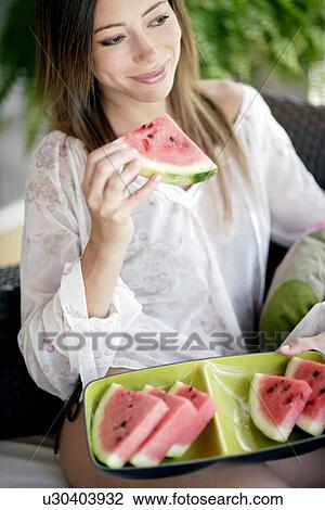 Woman eating watermelon View Large Photo Image Stock Image - Woman eating watermelon. Fotosearch