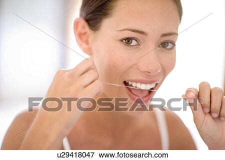 Woman flossing View Large Photo Image Stock Photo - Woman flossing. Fotosearch
