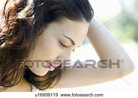 Stock Photo - Woman holding her hair back. Fotosearch