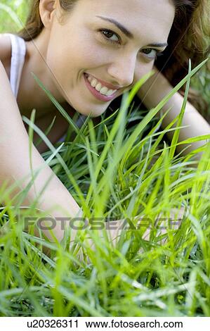 Woman lying on the grass View Large Photo Image Stock Image - Woman lying on the grass. Fotosearch