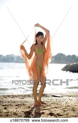 Stock Photo - Woman on a beach. Fotosearch