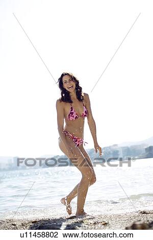 Stock Image - Woman playing in the sea. Fotosearch