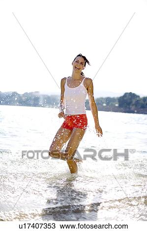 Woman playing in the sea View Large Photo Image Stock Image - Woman playing in the sea. Fotosearch