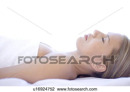 Stock Image - Woman relaxing at a spa. Fotosearch