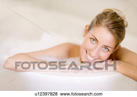 Stock Photo - Woman relaxing in a bath. Fotosearch