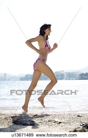 Woman running in the sea View Large Photo Image Stock Photo - Woman running in the sea. Fotosearch