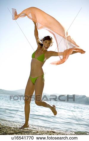 Woman running on a beach View Large Photo Image Stock Image - Woman running on a beach. Fotosearch