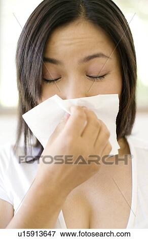 Stock Photo - Woman sneezing. Fotosearch