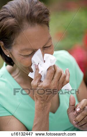 Stock Photo - Woman sneezing. Fotosearch