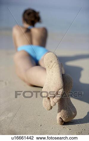 Woman sunbathing View Large Photo Image Stock Image - Woman sunbathing. Fotosearch