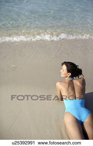 Woman sunbathing View Large Photo Image Stock Image - Woman sunbathing. Fotosearch