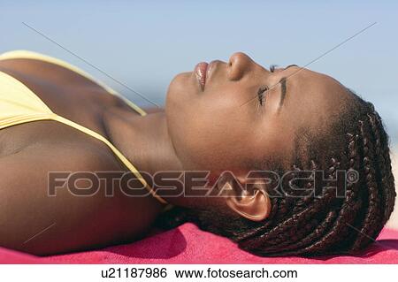 Stock Photograph - Woman sunbathing. Fotosearch