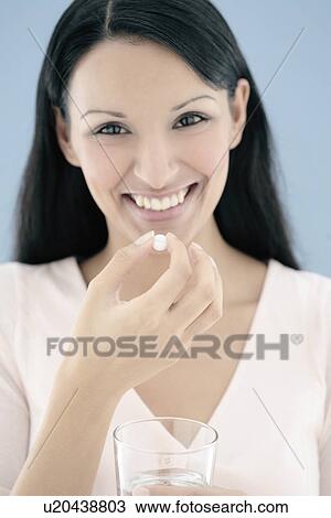 Woman taking a pill View Large Photo Image Stock Image - Woman taking a pill. Fotosearch