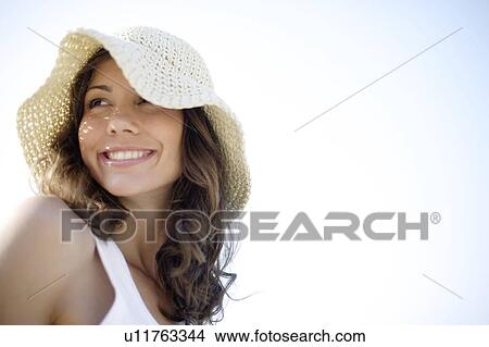 Picture - Woman wearing a sunhat. Fotosearch