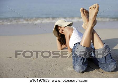 Stock Image - Woman wearing a sunhat. Fotosearch