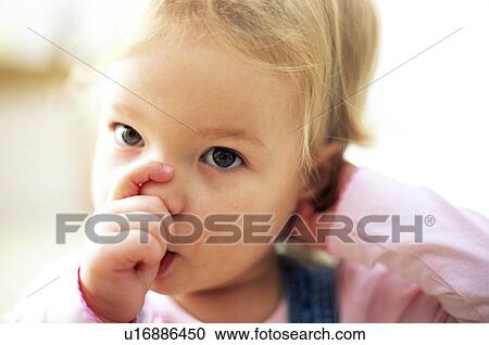 Stock Image - Young girl sucking thumb. Fotosearch