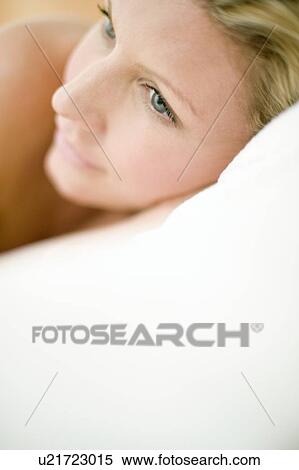 Young woman with head on pillow View Large Photo Image Stock Photography - Young woman with head on pillow. Fotosearch