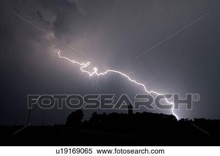 Stock Photography - A lightning bolt hits a farm, East of Princeton, Kansas, USA. Fotosearch