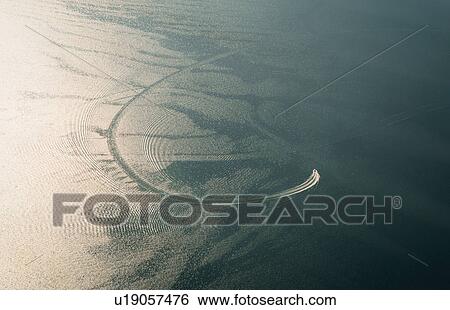 Stock Photograph - Aerial view of speed boat and boat wake on East river, New York, USA. Fotosearch