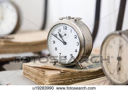 Alarm clock on weathered books View Large Photo Image Stock Image - Alarm clock on weathered books. Fotosearch