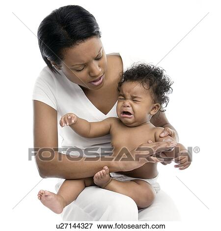Stock Photo - Applying skin cream to a baby. Fotosearch