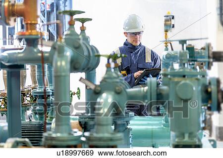 Apprentice worker in hydroelectric power station View Large Photo Image Stock Photo - Apprentice worker in hydroelectric power station. Fotosearch