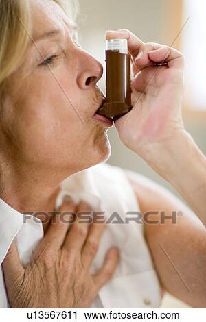 Stock Image - Asthma inhaler use. Fotosearch