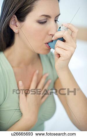 Stock Image - Asthma inhaler use. Fotosearch
