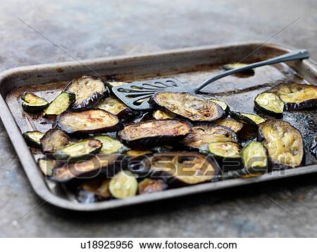 Aubergine slices on baking tray View Large Photo Image Stock Photograph - Aubergine slices on baking tray. Fotosearch