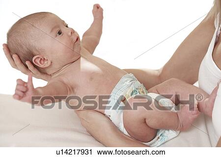 Baby being held by her mother View Large Photo Image Stock Image - Baby being held by her mother. Fotosearch