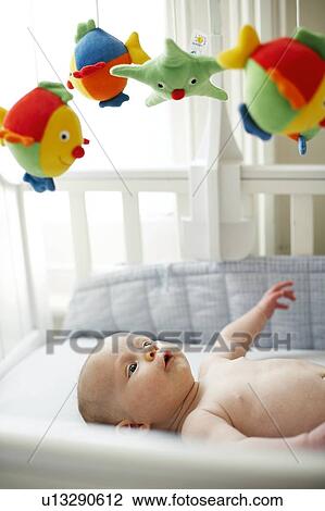 Baby boy in his cot View Large Photo Image Stock Image - Baby boy in his cot. Fotosearch