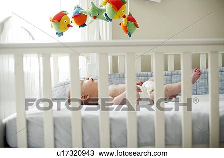 Baby boy in his cot View Large Photo Image Stock Image - Baby boy in his cot. Fotosearch