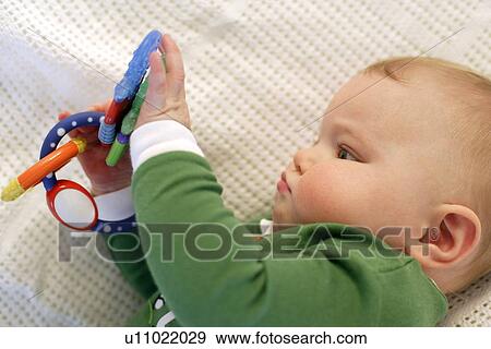 Stock Photo - Baby boy playing. Fotosearch