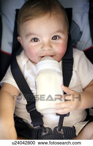 Stock Image - Baby drinking. Fotosearch