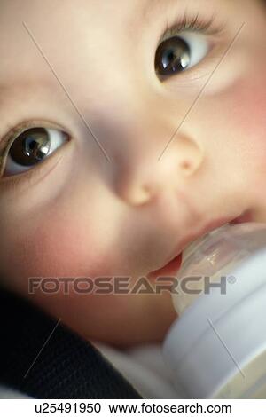 Stock Image - Baby drinking. Fotosearch