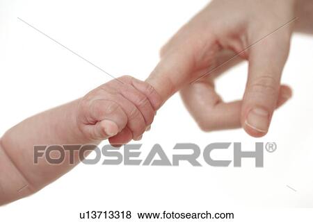 Baby holding her mother's finger View Large Photo Image Stock Photo - Baby holding her mother's finger. Fotosearch