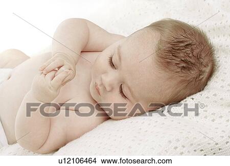 Picture - Baby lying on a blanket. Fotosearch