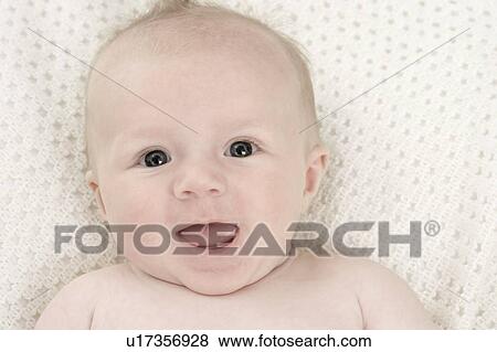 Stock Photo - Baby lying on a blanket. Fotosearch