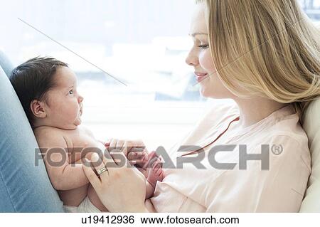 baby sitting on mother's lap View Large Photo Image Stock Photograph - baby sitting on mother's lap. Fotosearch