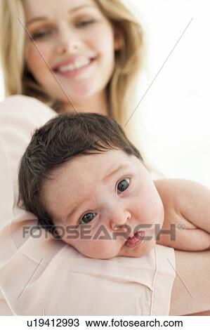 baby with mother in background View Large Photo Image Stock Image - baby with mother in background. Fotosearch