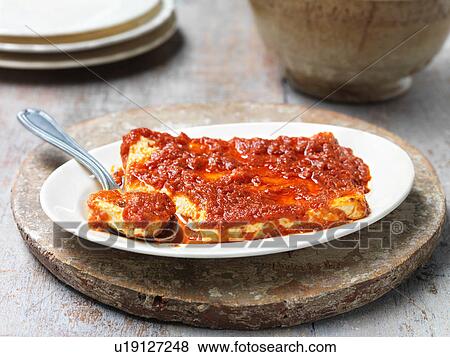 Baked feta cheese with sun dried tomato sauce, in bowl with spoon View Large Photo Image Stock Photo - Baked feta cheese with sun dried tomato sauce, in bowl with spoon. Fotosearch