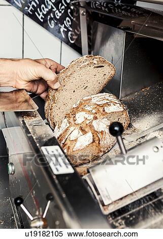 Baker with loaf of sliced bread View Large Photo Image Stock Photography - Baker with loaf of sliced bread. Fotosearch