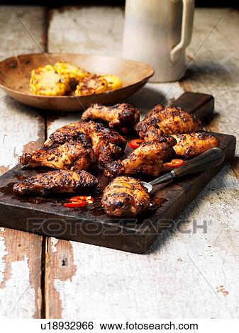 Stock Photograph - Barbecued peri peri chicken wings. Fotosearch