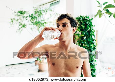 Bare chested man drinking water from bottle View Large Photo Image Stock Image - Bare chested man drinking water from bottle. Fotosearch