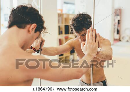 Bare chested man leaning against mirror looking down View Large Photo Image Stock Photo - Bare chested man leaning against mirror looking down. Fotosearch