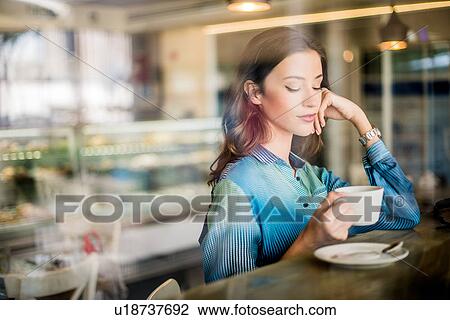 Beautiful woman at cafe window seat, Dubai, United Arab Emirates View Large Photo Image Stock Image - Beautiful woman at cafe window seat, Dubai, United Arab Emirates. Fotosearch