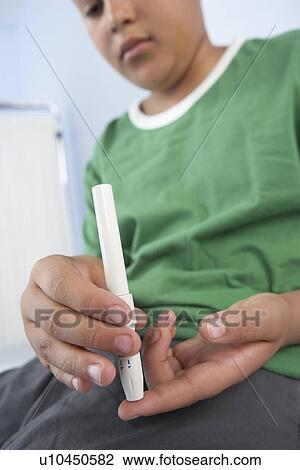 Stock Image - Blood glucose test. Fotosearch