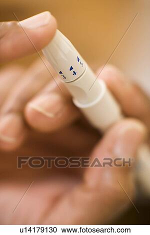 Stock Image - Blood glucose test. Fotosearch