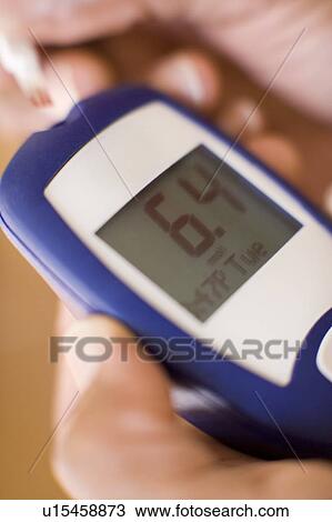 Stock Image - Blood glucose testing. Fotosearch